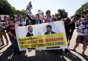 Tibetan, Chinese, Uighur and American activists rally outside the White House in Washington