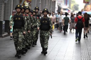 Paramilitary policemen patrol along a street in Shenzhen, Guangdong province, May 27, 2014. CREDIT: REUTERS/STRINGER