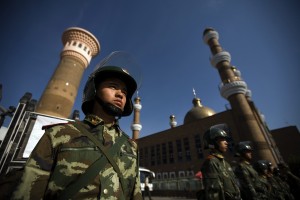 Security forces patrol the entrance to a mosque hours before Firday prayer in Urumqi, Xinjiang province, China, 10 July 2009.