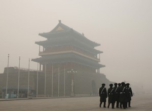 Paramilitary soldiers walk past the Zhengyangmen gate as they patrol at the Tiananmen Square during a heavily polluted day in Beijing