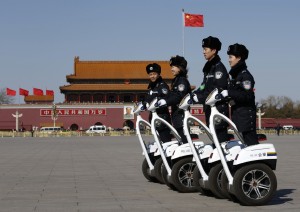 Police offices ride on motorized vehicles ahead of the opening session of Chinese People's Political Consultative Conference at Tiananmen Square in Beijing